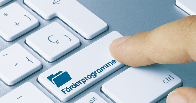 Förderprogramme Eine Tastatur mit Aufschrift Förderprogramme